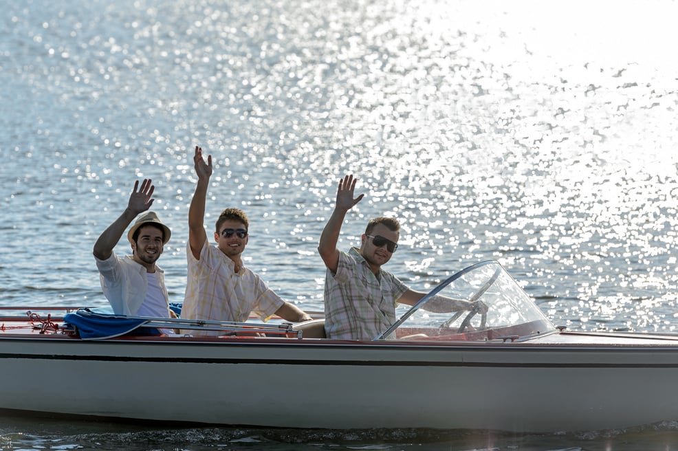 Waving Young Men Silhouette Driving Powerboat